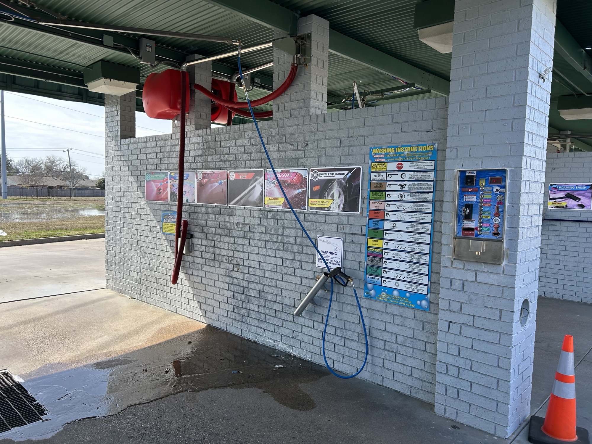 Self-serve bay wall with instruction decals, service signs, and payment controls