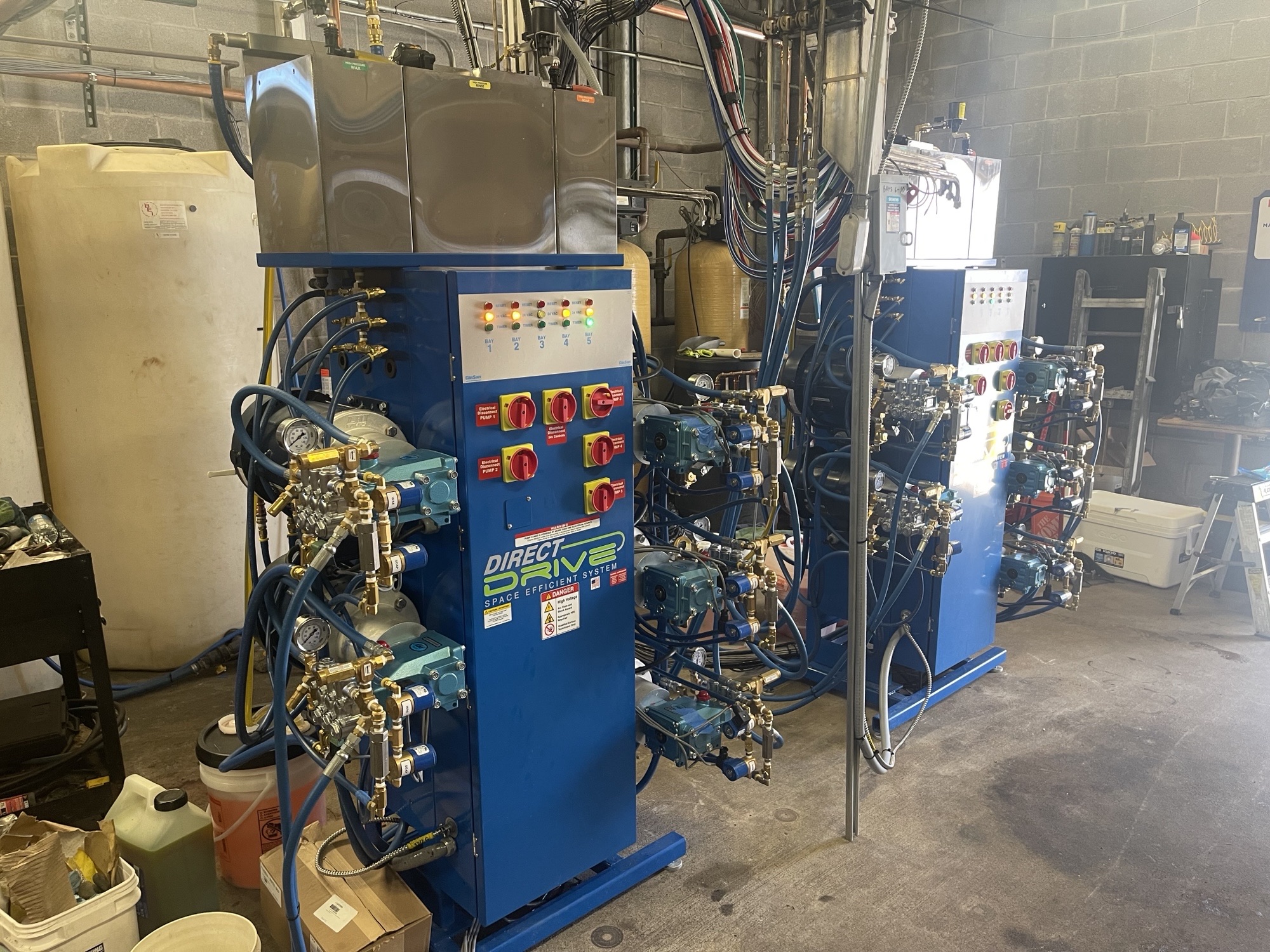 Blue Direct Drive carwash equipment installed inside an equipment room