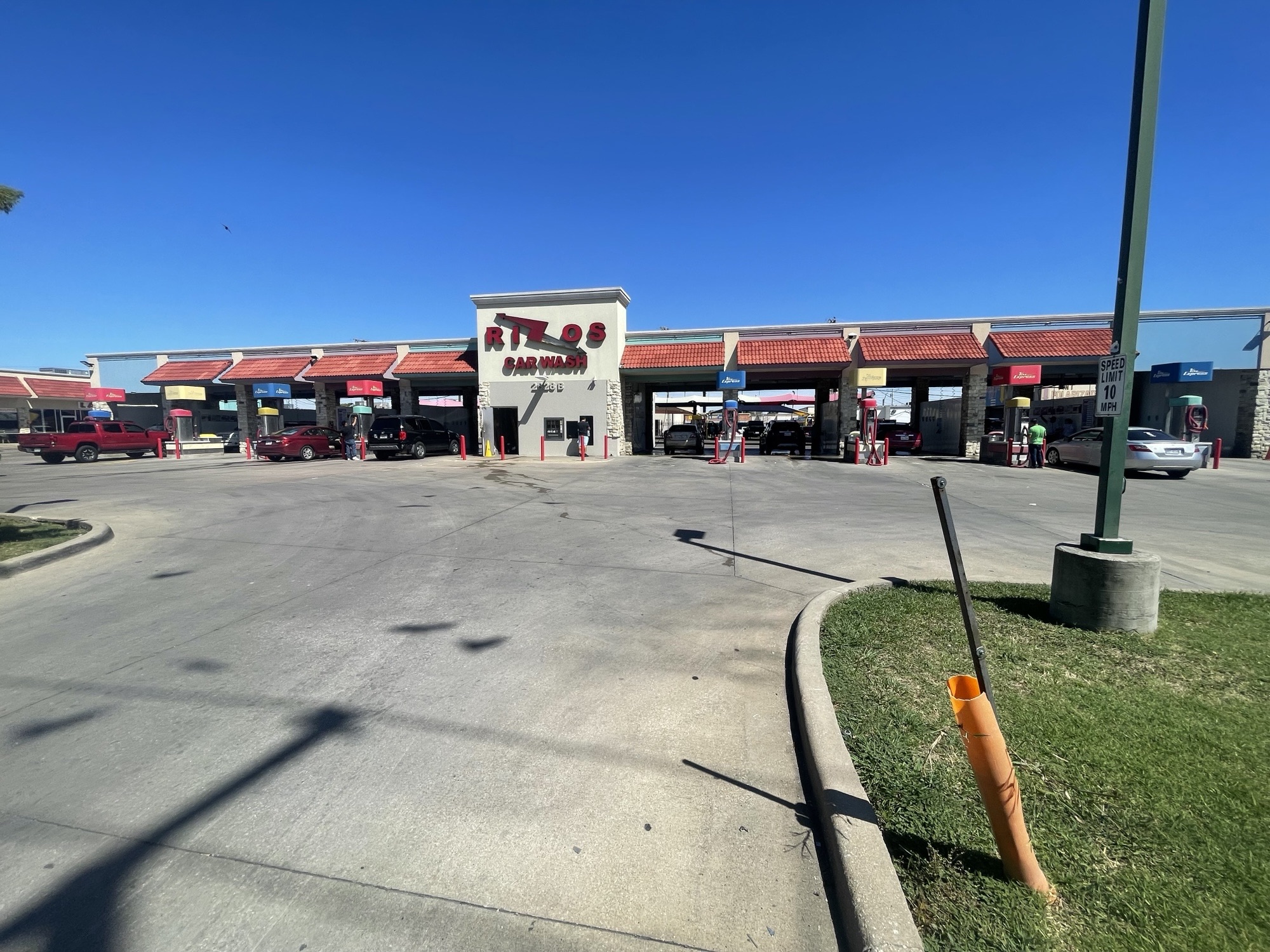 Exterior view of Rizos Car Wash with wash bays and vacuum stations